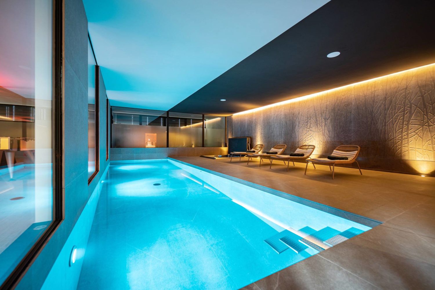 Un piscine intérieure dans une villa avec espace bien être - Nicollier